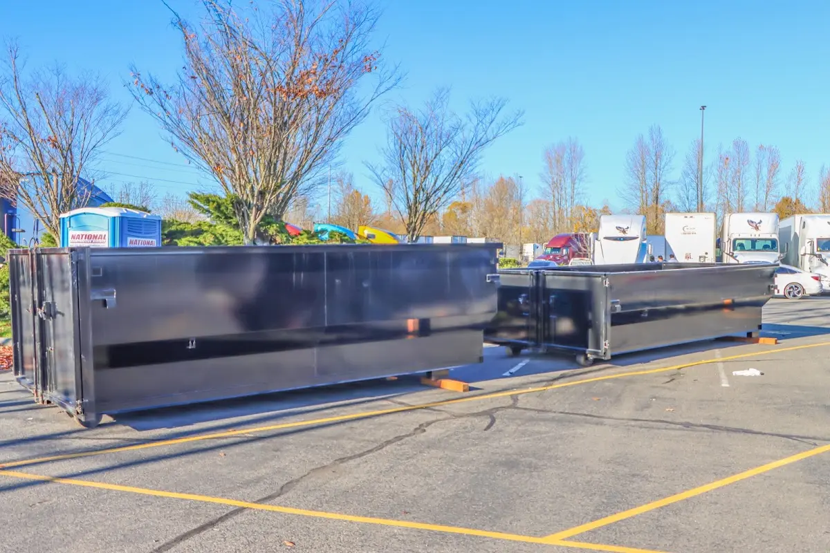 Professional dumpster rental service with roll-off container on residential driveway in Eastvale